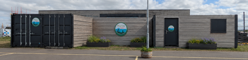 The same site after composite timber cladding, refreshed signage and planters.